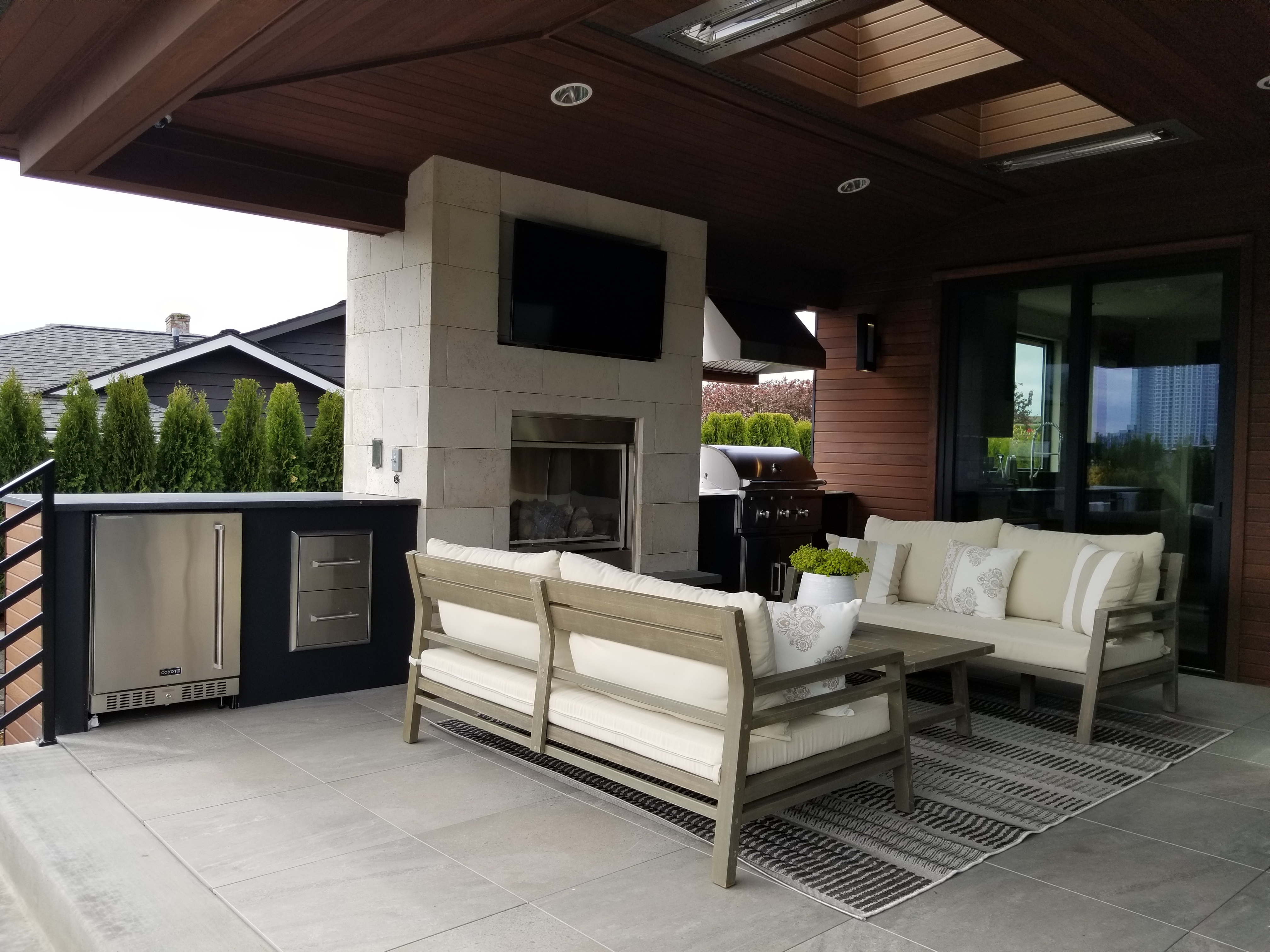 Stone veneer patio fireplace and outdoor living area